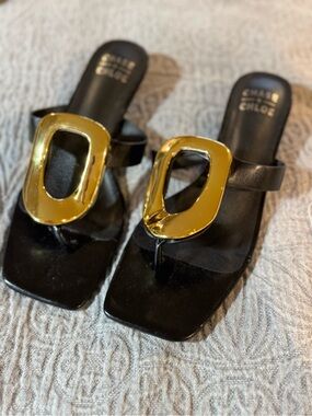 Chase & Chloe Black Vegan Leather Thong Sandals with Gold Buckle Detail